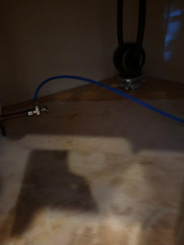 Repaired a leaking refrigerator ice maker supply line that had cracked after becoming crimped at the cabinet pass-through. Redrilled the cabinet penetrations to eliminate the pinch point and installed a new 10' length of 1/4" supply tubing from the kitchen sink shutoff valve to the refrigerator. Water service was maintained to the home throughout the repair.