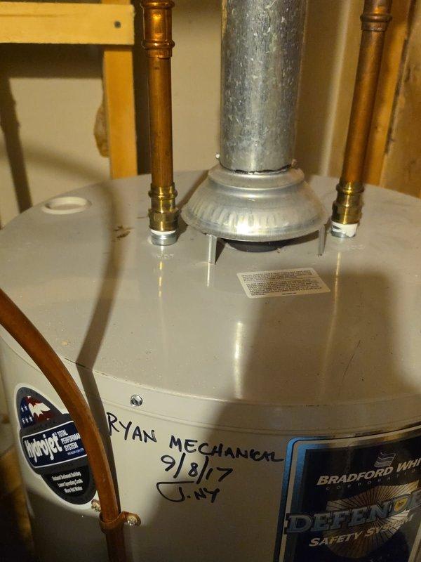 Replaced a failed 50-gallon standard-vent tank-type water heater with a new 50-gallon LP unit, reconnecting the water supply and outlet lines, gas supply, and draft hood to the existing flue. Verified proper venting, leak-free connections, and safe burner operation after startup.