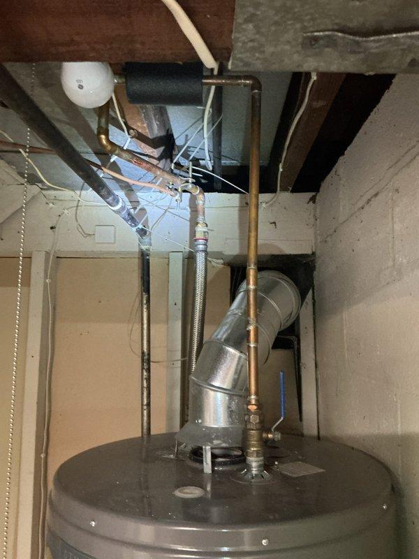 Evaluated the property for the requested garbage disposal installation and determined the disposal was not needed. Inspected the main shutoff, water heater connections, and supply piping, and documented the existing copper and galvanized lines, including an undersized 1/2" main and galvanized bathroom supply lines, as recommended candidates for a full water line repipe.
