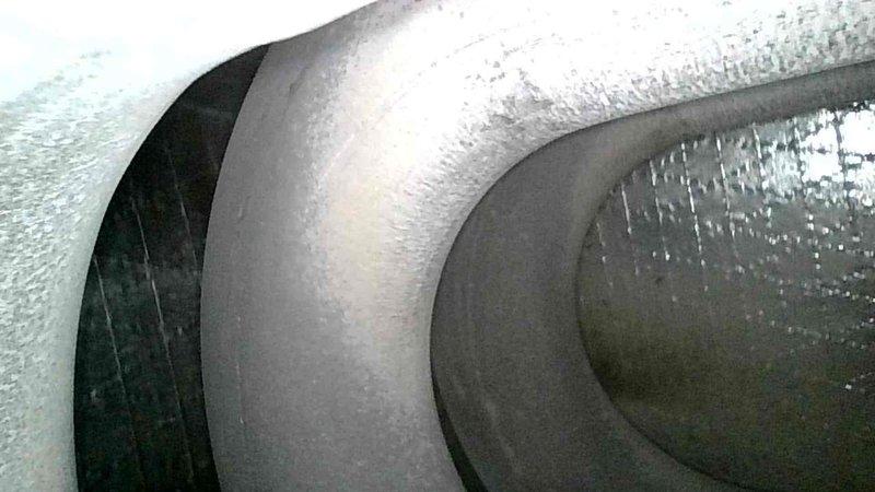Performed a seasonal tune-up on the Magic-Pak packaged HVAC system, inspecting the components and noting frost/ice accumulation on the evaporator coil and surrounding surfaces, which indicates a possible airflow restriction or refrigerant-related issue requiring further evaluation. The Honeywell steam humidifier canister requires replacement, and a return visit has been scheduled to install the part.