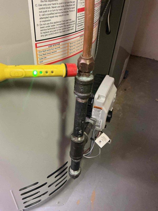 Responded to a callback for a strong gas odor at a newly installed water heater. Using a combustible gas detector, traced the leak to the flare nut at the heater's gas connection, then tightened the nut and replaced the flare end on the connector. Re-tested the fitting with the detector and confirmed no gas leakage remained.