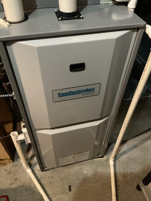Diagnosed a no-heat condition on a 24-year-old Comfortmaker gas furnace and found a leaking collector box and draft inducer motor, with heavy corrosion and mineral deposits on the combustion area panel, along with gas valve and pressure switch faults. Documented the failed components and corrosion damage, and presented repair options and required parts to the customer.