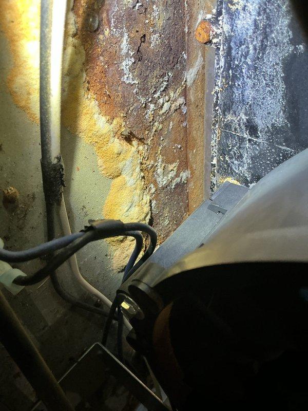 Diagnosed a no-heat condition on a 24-year-old Comfortmaker gas furnace and found a leaking collector box and draft inducer motor, with heavy corrosion and mineral deposits on the combustion area panel, along with gas valve and pressure switch faults. Documented the failed components and corrosion damage, and presented repair options and required parts to the customer.