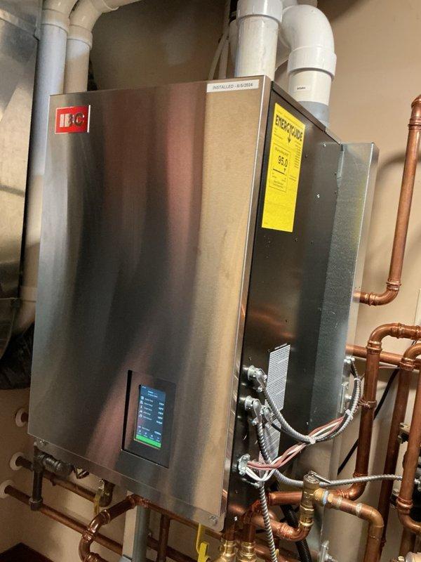 Diagnosed a no-hot-water condition on a two-year-old wall-mounted condensing boiler (IBC VX110) and determined the control board had failed. Sourced and installed a replacement control board, then reset all programming and parameters, restoring normal operation and hot water production. A vent temperature warning displayed during startup and cleared on its own; the unit, venting, and copper piping were inspected and showed no leaks, corrosion, or visible damage.