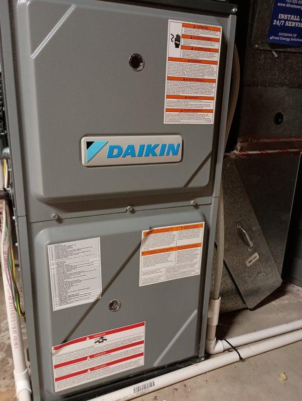 Responded to a no-heat call on a 6-year-old Daikin gas furnace that was short-cycling and locking out, with the thermostat displaying an E0 gas furnace fault and the control board logging an E9 high-stage pressure switch stuck-open code. Inspected the draft inducer pressure switch circuit and found a clogged pressure switch tube, which was preventing the hot surface igniter from energizing. Cleared the obstruction, reset the control board, and ran the furnace through a full heating cycle, confirming normal ignition, burner operation, and proper heat output. System is operating normally and heating as intended.