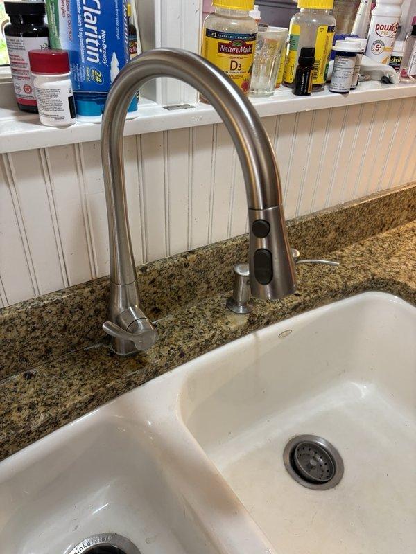 Inspected the kitchen sink cabinet for a reported leak and traced discoloration on the rear wall to water escaping from the base of the faucet handle, running along the countertop and down into the cabinet space; the countertop seal was also found to be deteriorated. Prepared a parts order for a replacement faucet cartridge and a new kitchen faucet to correct the leak.