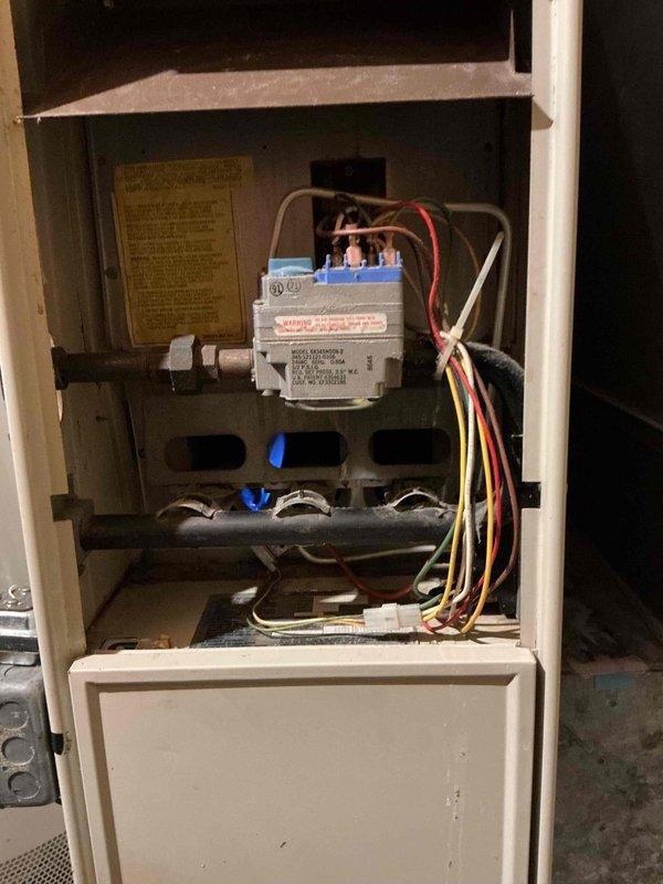 Responded to a no-heat call on a 40-year-old Carrier forced-air gas furnace and diagnosed a failed heat fan relay (HFR) on the control board, which prevented the blower from operating in "auto" mode from the thermostat. Because the relay is soldered directly to the board, the repair requires full control board replacement. Verified burner ignition and flame operation at the gas valve and manifold, and documented the unit's condition and the required repair.