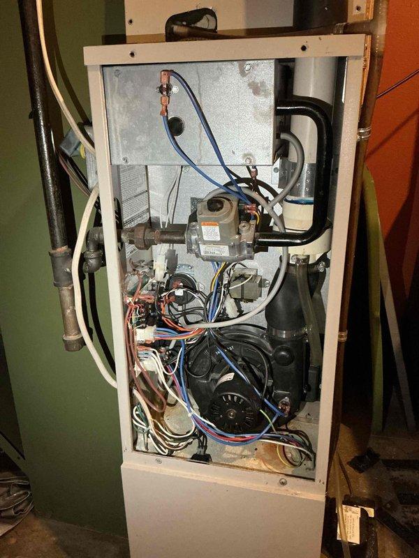Diagnosed a no-heat condition on a 5-year-old gas furnace presenting a pressure switch open fault with the inducer energized. Found the equipment locked out due to a failed control board, and noted surface corrosion on the vent/duct seam and cabinet floor during inspection. Provided repair options and the customer is considering next steps.