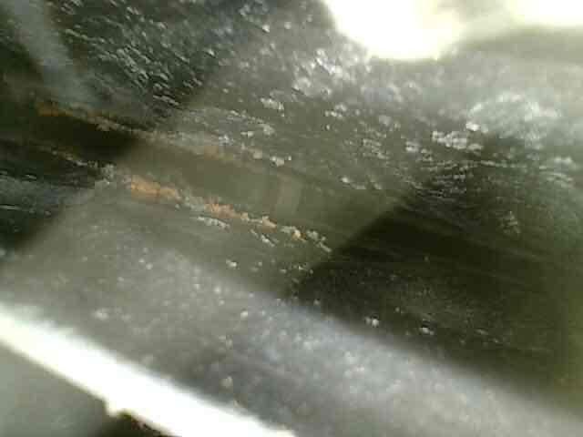 Diagnosed a no-heat condition with a "system malfunction" thermostat error and found the furnace overheating. Inspection of the secondary heat exchanger revealed significant leaking, with rust, corrosion, and mineral buildup visible along the seams. Due to the safety concern, the unit was tagged out and an advisor appointment was scheduled to review repair or replacement options.