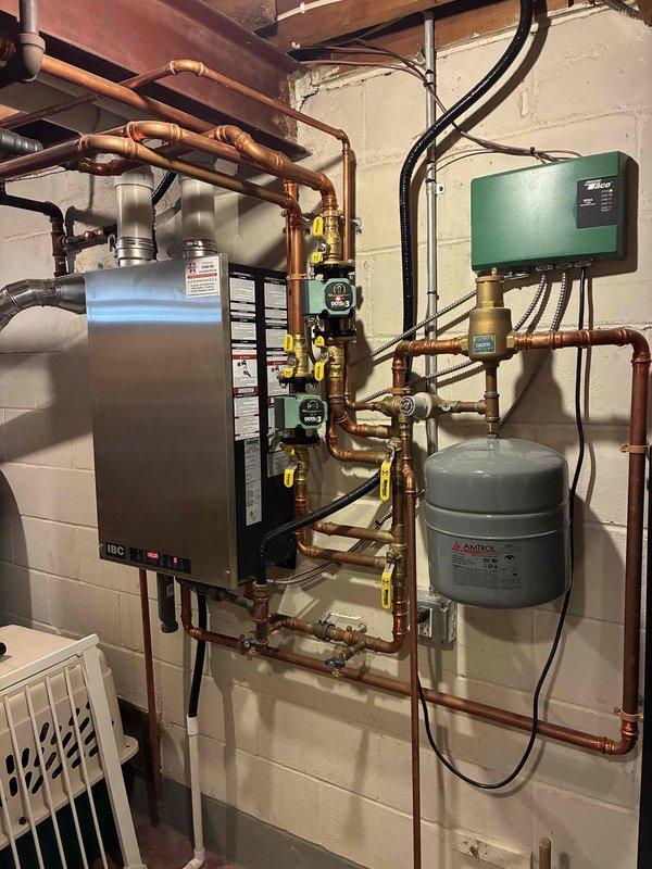 Performed pre-season preventive maintenance on a wall-mounted IBC boiler, including inspection and cleaning of routine components and verification of proper operation. Bled air from the radiators to restore full hydronic circulation. No deficiencies found; the boiler, circulators, copper piping, and expansion tank showed no leaks or corrosion, and the system is operating as designed.