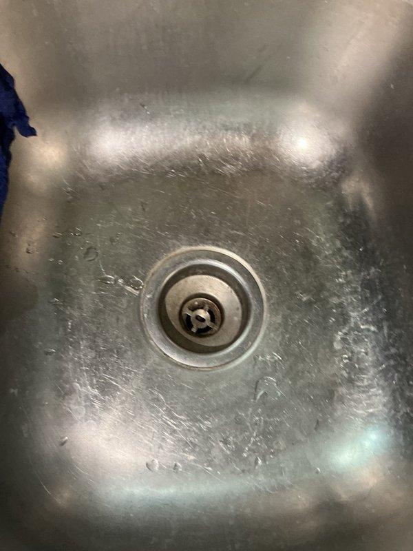 Diagnosed a leaking kitchen sink and traced the leak to the drain openings, where both basket strainer assemblies had failed due to age and corrosion. Removed and replaced both basket strainers, reassembled the drain connections, and confirmed the drains hold water with no leaks.