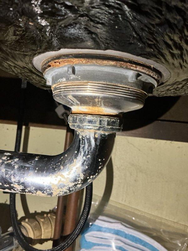 Diagnosed a leaking kitchen sink and traced the leak to the drain openings, where both basket strainer assemblies had failed due to age and corrosion. Removed and replaced both basket strainers, reassembled the drain connections, and confirmed the drains hold water with no leaks.