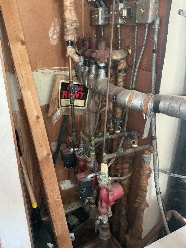 Responded to a no-heat call on a 50+ year old hydronic boiler and found the electrical breaker tripped; resetting it restored boiler operation. Flue gas analysis measured CO in excess of 1100 ppm, well above the 400 ppm maximum for vented heating appliances, so the unit was deemed unsafe to operate. Noted deteriorated, frayed pipe insulation and corrosion on the manifold piping and valves, and scheduled a same-day estimate for boiler replacement.
