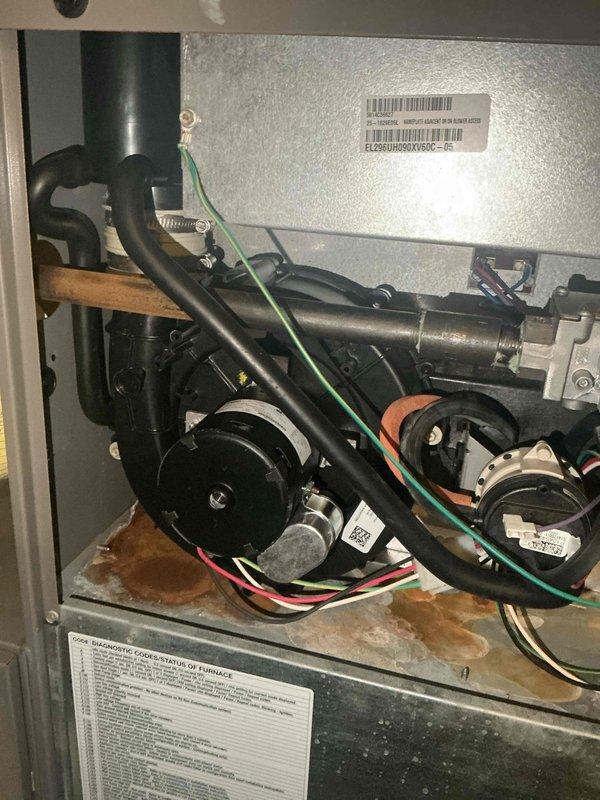 Replaced the PSC combustion inducer draft motor and blower assembly along with the associated gasketing on the gas furnace. Inspection revealed heavy rust and corrosion on the cabinet floor beneath the inducer assembly, indicating prior moisture exposure. After installation, the furnace was tested and is fully operational.