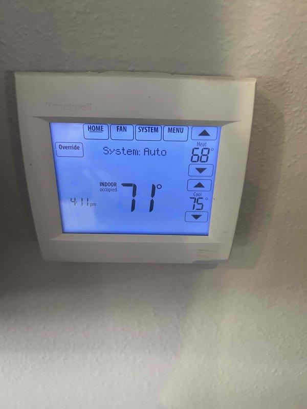 Responded to a complaint of inconsistent room temperatures and inadequate heating. Inspected the system and determined the unit is a single-stage split system with a single thermostat and no zoning capability, so individual room temperatures cannot be independently controlled. Thermostat was verified operating normally in auto mode (heat setpoint 68°, cool setpoint 75°, space at 71°), and the ongoing building addition, with the west-side RTU removed, is likely contributing to the uneven heat distribution. No repair was possible; the issue is a system design limitation rather than an equipment failure.