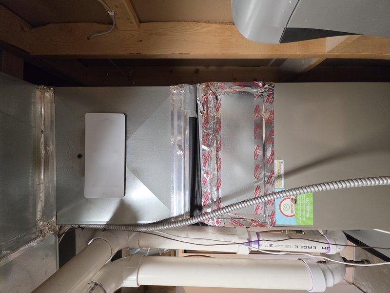 Responded to an install callback and secured the cased coil side panel that had come loose, using a longer screw for a positive hold. Sealed the gap at the vinyl boot overlap on the supply plenum with foil tape to eliminate air leakage. Identified the loose low-voltage wire as the humidifier's outdoor temperature sensor lead and removed it, as the unit is configured to operate without the ODT sensor; all other components were inspected and found in good order.