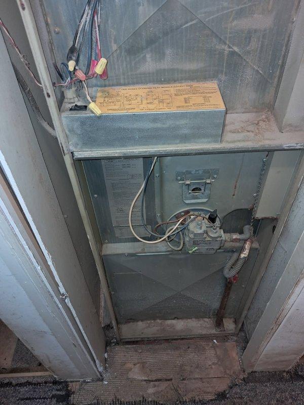 Diagnosed a no-heat condition on a 35-year-old Coleman 7975-856 standing-pilot mobile-home furnace. The pilot was proven, but the main burner would not ignite. The transformer tested good at 120 VAC primary and 29 VAC secondary, and the gas valve coil measured 64 Ω. An open limit switch near the blower motor was interrupting the heat circuit and preventing 24 VAC from reaching the gas valve. Due to the age and condition of the unit, the furnace was left off pending replacement consultation. If repair is elected, the limit switch must be replaced with the correctly rated safety component, followed by verification of a complete heating cycle and temperature rise.