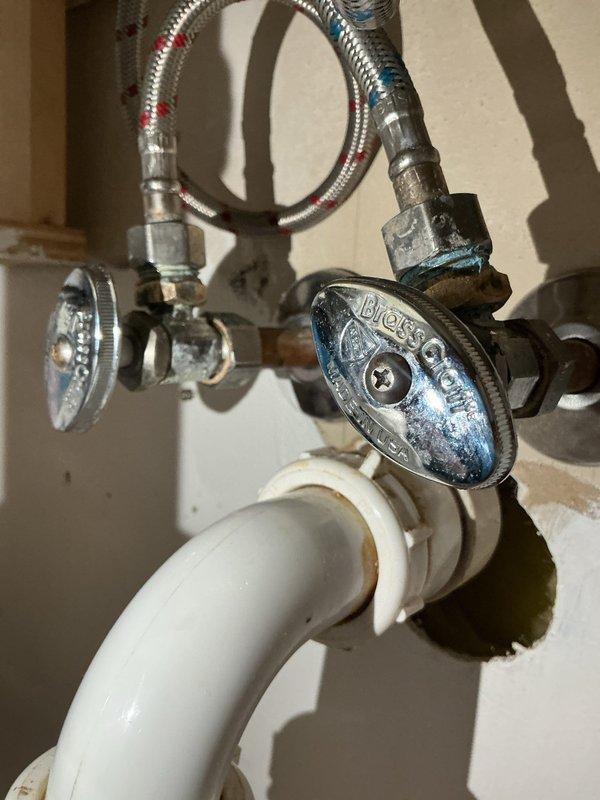 Diagnosed a water leak at the main-level bathroom lavatory, where the hot and cold supply lines and angle stop connections on the aging 27-year-old plumbing were leaking and dripping through the floor into the basement. Disassembled the affected supply connections, cleaned the corroded and mineral-encrusted fittings, and reassembled them to restore watertight operation.