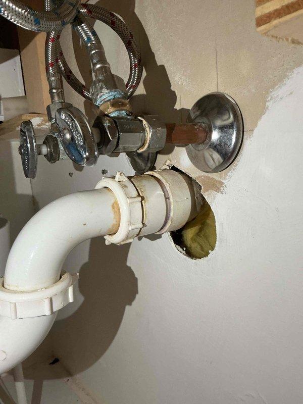 Diagnosed a water leak at the main-level bathroom lavatory, where the hot and cold supply lines and angle stop connections on the aging 27-year-old plumbing were leaking and dripping through the floor into the basement. Disassembled the affected supply connections, cleaned the corroded and mineral-encrusted fittings, and reassembled them to restore watertight operation.