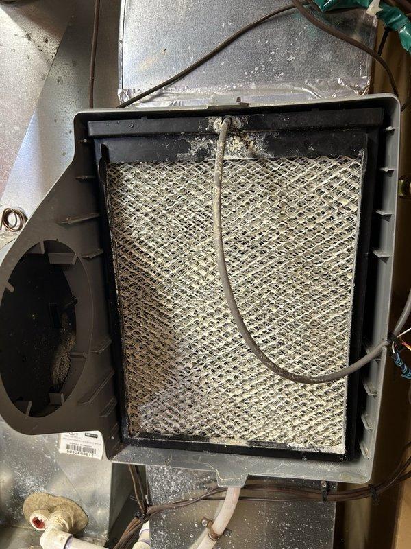 Performed annual maintenance on a 2013 gas furnace, including cleaning the flame sensor and inspecting ignition, burners, blower wheel, inducer motor amperage, flame sensor microamps, gas valve, and gas pressure. Scoped the heat exchanger and found no defects, with safe carbon monoxide levels and combustion results confirming 93.6% efficiency. The system is operating properly. Noted heavy mineral scaling on the humidifier water panel and recommended replacing the filter and humidifier pad to keep up with ongoing maintenance.