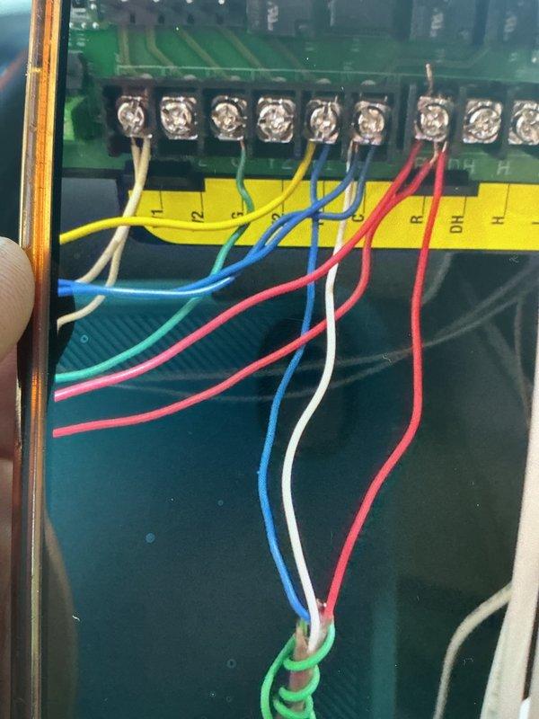 Responded to an install callback for a no-cool complaint; found the air handler blowing air with no cooling due to incorrect low-voltage thermostat wiring at the control board terminal block. Corrected and re-terminated the control wiring (R, C, Y, G) at the board, secured the connections, and verified proper system operation, confirming the installation is complete.