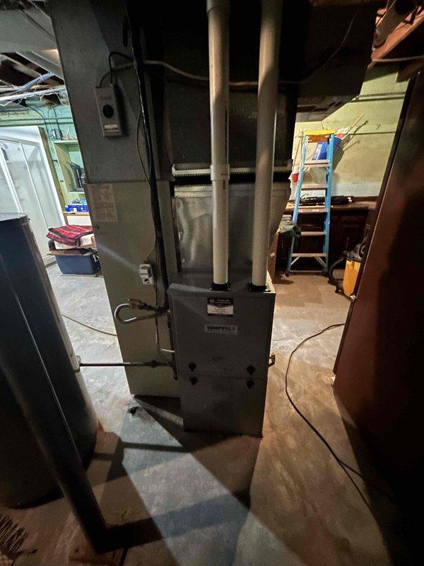Performed a complete furnace tune-up on a Tempstar upright gas furnace, which was found operating properly with no deficiencies. Inspected the condensate drain line, which transitions from 7/8" to 3/4" tubing, and verified it was clear by blowing through it; mineral buildup was noted on the ribbed drain components, and the homeowner was advised it will recur in a couple of years. Homeowner elected to defer replacement of the vinyl drain line at this time.