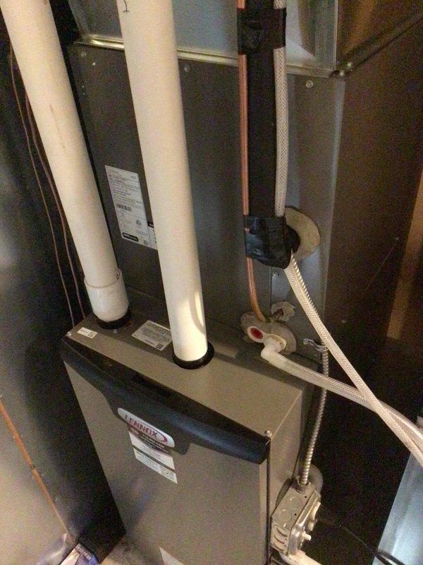 Performed seasonal maintenance on the Lennox gas furnace and split-system air conditioner, confirming both systems were operating properly. Inspected the furnace and evaporator coil cabinet, noting clean, intact equipment with no visible frost, corrosion, or damage, and replaced the furnace filter with the correct size. Found the outdoor condenser coils heavily clogged with dirt, lint, and debris, which should be addressed through coil cleaning to maintain airflow and cooling efficiency.
