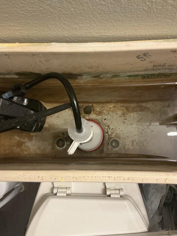 Investigated a reported suspected water leak and elevated water usage by inspecting the water heater and toilet. Diagnosed a continuously running toilet caused by a failed flush valve, which was the source of the water loss, and replaced the flush valve assembly to restore proper tank fill and shutoff operation.