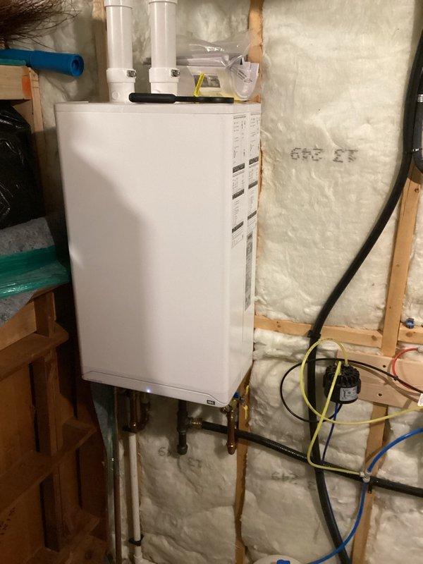 Diagnosed a no-hot-water condition on a one-year-old tankless water heater with an ignition failure and active error code. Gas pressure testing showed a 3" w.c. drop at high fire and combustion analysis showed CO2 slightly outside the acceptable range, indicating a restricted heat exchanger and an undersized gas supply (approximately 5 ft. of gas line where 10 ft. is required). Scheduled an HVAC technician to clean the heat exchanger and extend the gas line.