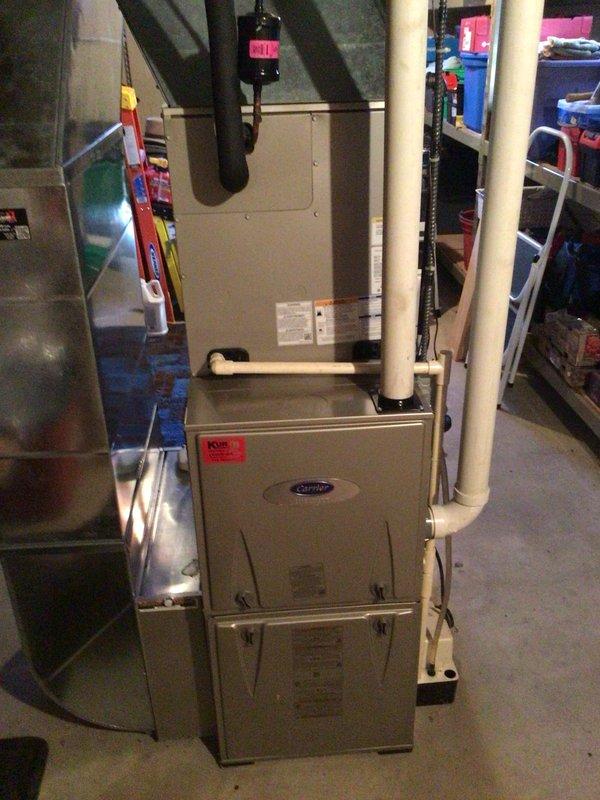 Performed a scheduled maintenance tune-up on a Carrier vertical gas furnace under the recurring service agreement. Cleaned the flame sensor and tested electrical components, with all readings within manufacturer specifications. Confirmed the filter was new and verified the unit is operating properly with no issues found.