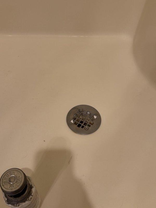 Located the water leak at the master bathroom shower and determined the source to be a failed plumber's putty seal at the shower drain flange. Removed the drain strainer, thoroughly cleaned the flange and surrounding surface of mineral deposits and debris, and resealed the drain with silicone to restore a watertight seal.