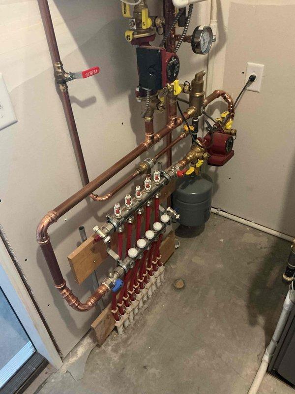 Diagnosed a Navien boiler serving the radiant floor heating system that was faulting on a low water pressure error code. Opened the system fill valve and repressurized the loop to approximately 15 psi, then monitored operation to confirm the boiler fired, held pressure, and heated properly. Instructed the homeowner on how to read the system pressure gauge and manually add water to maintain proper pressure.
