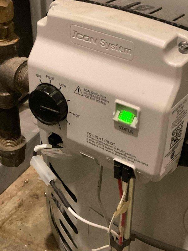 Responded to a no-hot-water complaint on a gas tanked water heater following a recent HVAC system installation. Inspected the ICON System gas control valve and found the temperature dial set too low, with the status indicator showing normal operation and pilot ignition intact. Adjusted the control dial to the proper heating setting, restoring hot water production.
