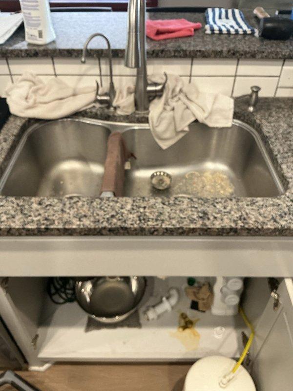 Diagnosed a recurring kitchen sink backup caused by a blockage of food debris and sludge. Disassembled the drain and cabled the line its full length, clearing the obstruction at approximately 30 feet, then ran water while cabling the remainder to flush debris from the line. Reassembled the drain and verified proper drainage with no leaks; recommended replacing the under-sink Studor vent, which has a 10-year service life.