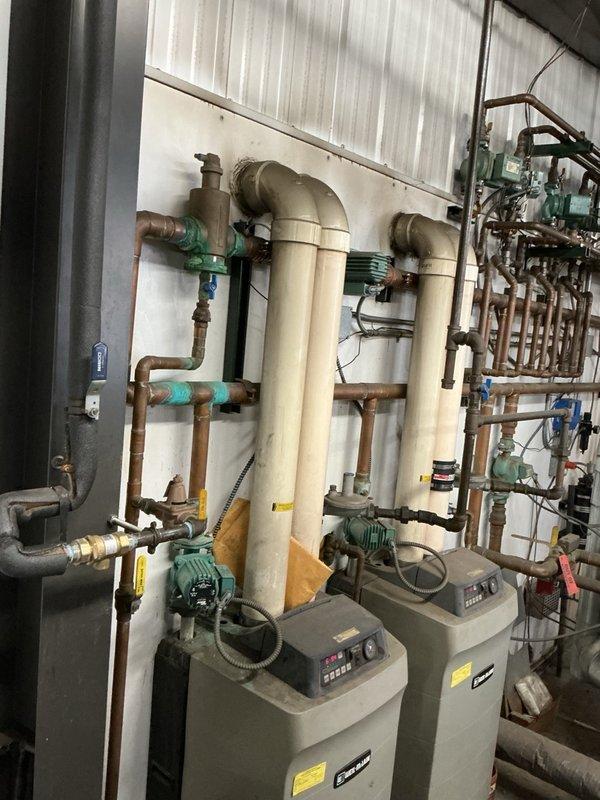 Responded to a water leak in the commercial mechanical room and identified a leaking backflow preventer on the hydronic boiler makeup water piping. Isolated the line, removed the failed unit, and installed a new Watts 9D backflow preventer. Restored water supply and verified the assembly operates properly with no leaks.