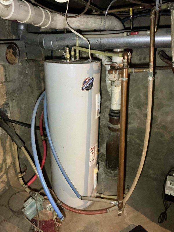 Diagnosed reduced hot water output on the electric tank-type water heater and found heavy sediment buildup in the tank that had burned out the lower heating element. Because sediment accumulation of this extent compromises tank integrity and efficiency, replacement of the unit is recommended, and an estimate for a new water heater was provided.