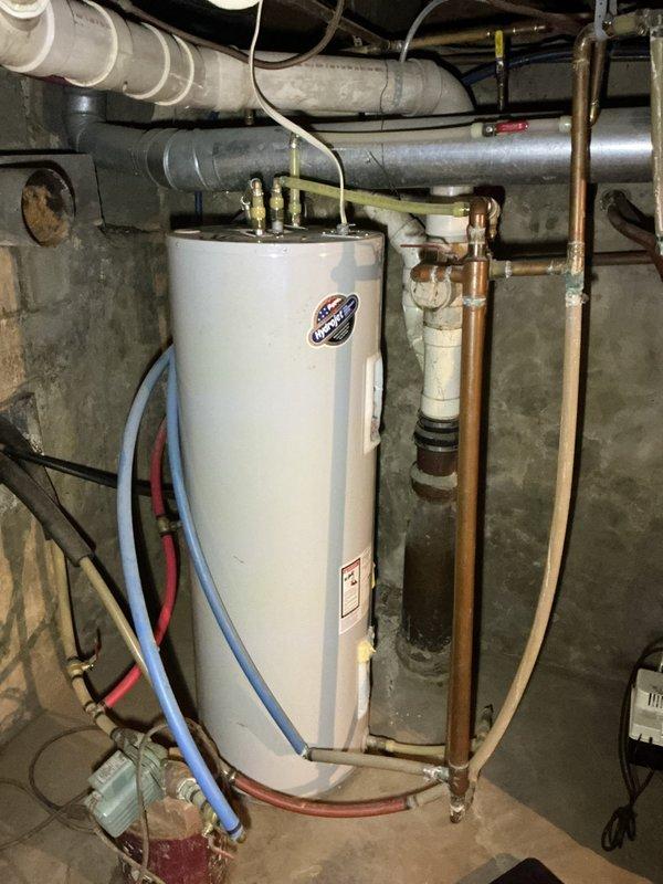 Diagnosed reduced hot water output on the electric tank-type water heater and found heavy sediment buildup in the tank that had burned out the lower heating element. Because sediment accumulation of this extent compromises tank integrity and efficiency, replacement of the unit is recommended, and an estimate for a new water heater was provided.