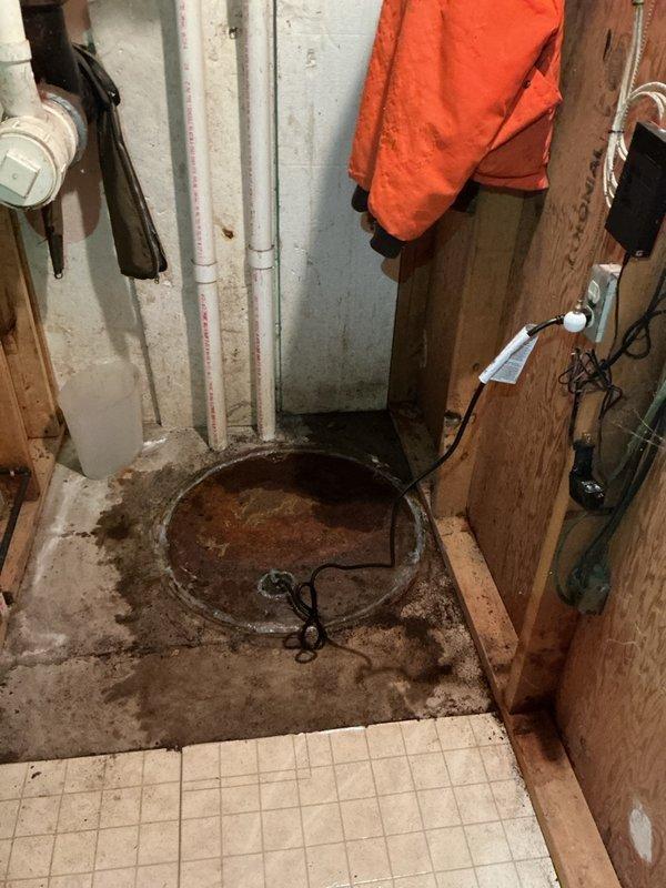 Installed the customer-supplied toilet and diagnosed the second toilet's flushing issue, which was traced to a heavily corroded cast-iron closet flange with cracked surrounding floor tile; the flange requires rebuilding with a mechanical repair flange. The basement sump pit was also inspected, and the existing pump was found to need replacement with a new grinder pump. Both repairs have been forwarded to on-call for scheduling and completion.