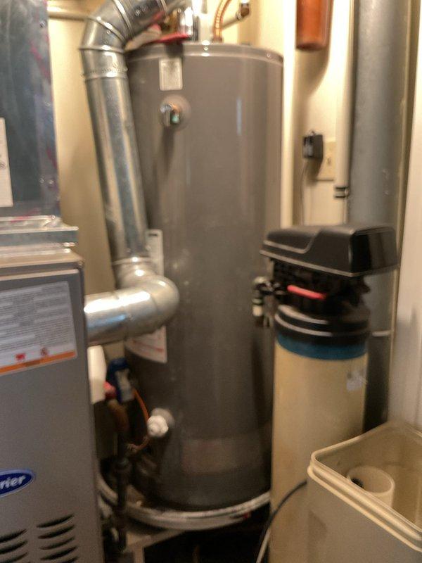 # Service Report: Gas Water Heater - No Hot Water

Responded to service call for gas water heater with no hot water production. Upon arrival, located unit in kitchen utility closet adjacent to furnace system. Performed comprehensive diagnostic inspection of gas-fired water heater, including visual assessment of all major components, gas supply line, pilot assembly, burner operation, and venting system. Inspected associated plumbing connections, temperature and pressure relief valve, and gas control valve functionality. Evaluated exhaust venting for proper draft and clearance. Documented existing conditions of water heater and surrounding mechanical systems, including adjacent HVAC equipment and water treatment system. Completed troubleshooting procedures to identify cause of hot water failure and provided recommendations for restoration of service.