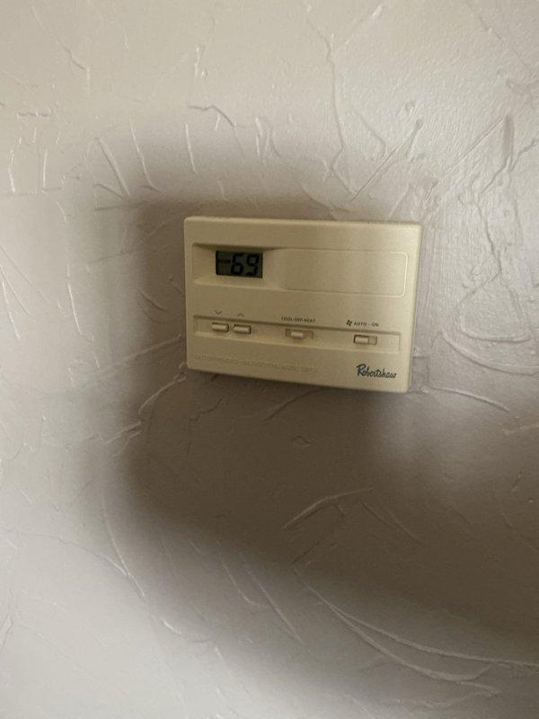 Responded to service call for HVAC system replacement estimate at residential property. Upon arrival, accessed equipment through back entrance and conducted thorough assessment of existing heating and cooling system. Evaluated current Robertshaw digital thermostat displaying operational status and inspected basement-mounted furnace unit with associated hydronic heating components including circulation pump, PVC condensate piping, and supply/return connections. Documented equipment age, condition, and configuration through photographs. Measured existing unit dimensions to determine replacement specifications and reviewed available space for new equipment installation. Assessed electrical service, gas connections, ductwork accessibility, and existing piping infrastructure to provide comprehensive replacement options. Prepared estimate for complete system replacement with appropriate equipment sizing recommendations based on current installation parameters.