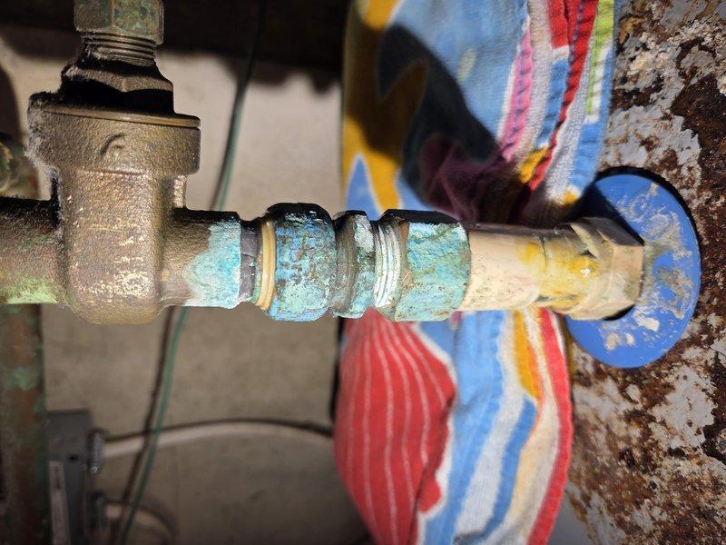 Completed comprehensive tune-up and inspection on heat pump system in cooling mode. Performed standard maintenance procedures including checking refrigerant levels, inspecting electrical connections, testing thermostat operation, and verifying proper airflow and system performance. Documented existing plumbing infrastructure in mechanical area showing significant copper pipe corrosion and oxidation on associated water heating equipment, though primary heat pump system operating within normal parameters at time of service.