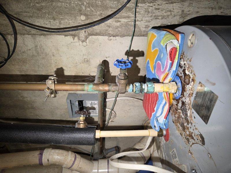 Completed comprehensive tune-up and inspection on heat pump system in cooling mode. Performed standard maintenance procedures including checking refrigerant levels, inspecting electrical connections, testing thermostat operation, and verifying proper airflow and system performance. Documented existing plumbing infrastructure in mechanical area showing significant copper pipe corrosion and oxidation on associated water heating equipment, though primary heat pump system operating within normal parameters at time of service.