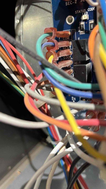 Responded to service call for furnace that would not shut off when reaching set temperature. Unit located on second floor in utility closet serving right side of residence. Upon inspection, diagnosed issue with thermostat control circuit and wiring connections at control board. Examined SEC-2 SE status board and terminal connections, noting multiple wire terminations requiring attention. Tested electrical continuity and voltage readings using digital clamp meter to verify proper circuit operation. Addressed faulty control signal preventing proper cycle termination, ensuring furnace now responds correctly to thermostat satisfaction calls and shuts down as designed.