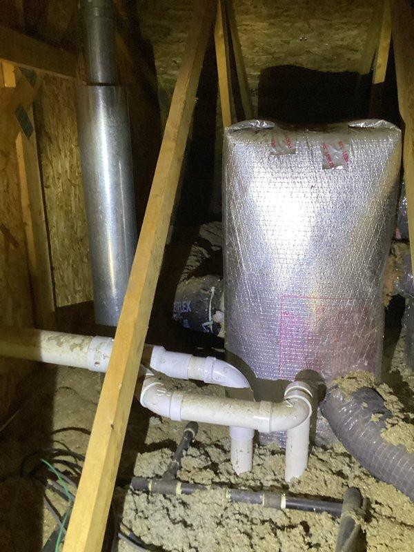 Replaced defective 2-inch elbow fitting on furnace flue system located in attic space. Installed two 2-inch couplings and one 2-inch 90-degree elbow to restore proper venting configuration. All PVC connections were properly fitted and secured to ensure safe exhaust ventilation from the heating unit.