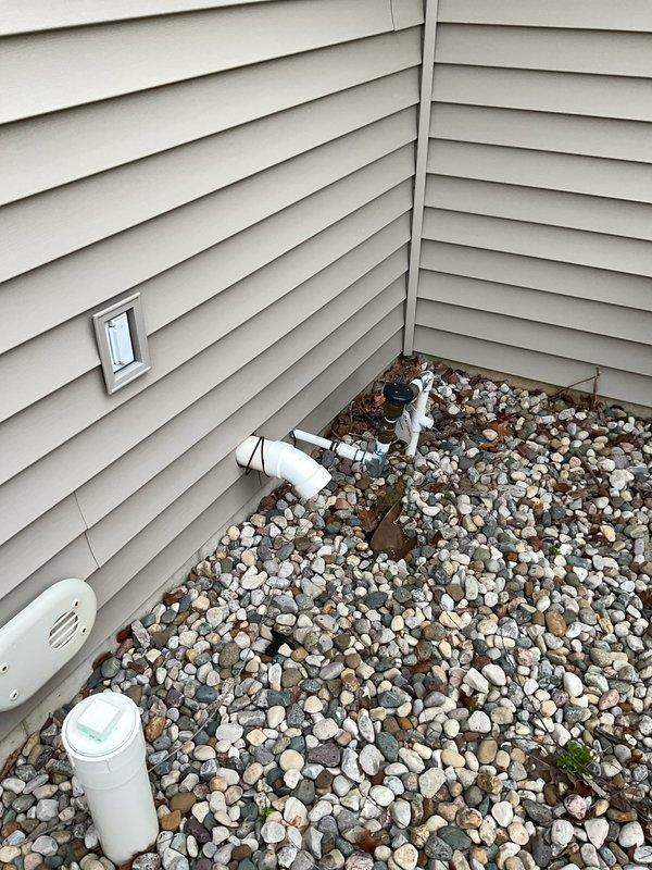 Corrected improperly terminated flue pipe at exterior foundation by installing two 90-degree elbows to redirect exhaust above ground level per code requirements. Repaired leaking supply line and valve assembly at master bathroom tub, replacing faulty components and pressure testing system to ensure proper seal and function.