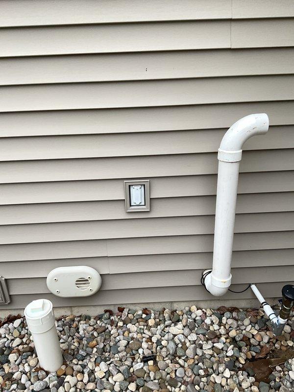 Corrected improperly terminated flue pipe at exterior foundation by installing two 90-degree elbows to redirect exhaust above ground level per code requirements. Repaired leaking supply line and valve assembly at master bathroom tub, replacing faulty components and pressure testing system to ensure proper seal and function.