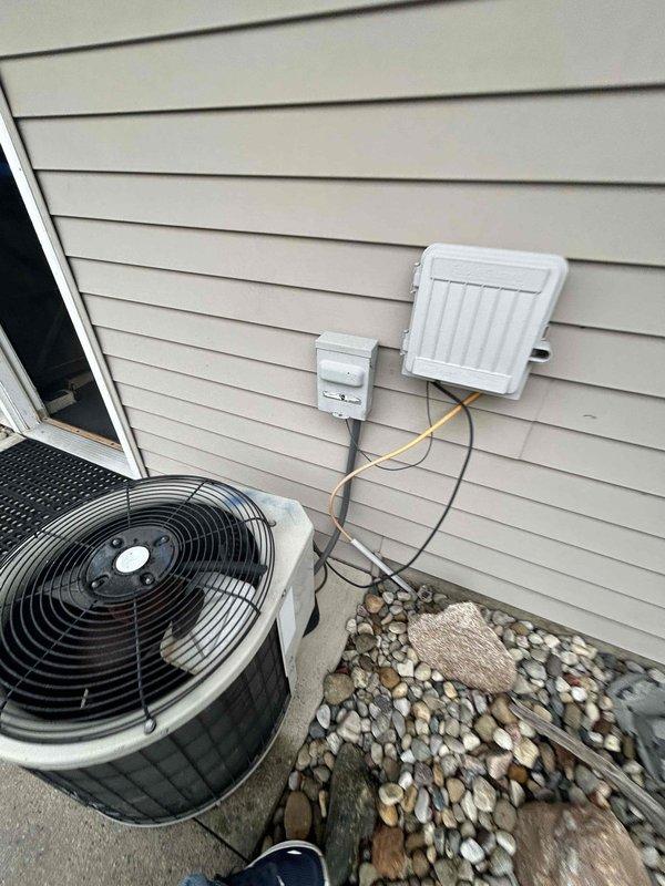 Conducted comprehensive assessment of existing HVAC system at duplex residence for complete gas furnace and air conditioning replacement. Homeowner reported inadequate cooling performance during previous season with elevated utility costs, attributed to potentially undersized equipment for space with high ceilings. Evaluated garage-mounted furnace installation and exterior condensing unit. Documented current system configuration including ductwork, electrical connections, and equipment placement. Photographed existing outdoor AC unit on concrete pad with associated electrical conduit and indoor furnace unit with visible air filtration system. Provided detailed replacement estimate addressing proper equipment sizing requirements to accommodate elevated ceiling heights and improve cooling efficiency. Discussed financing options as requested.