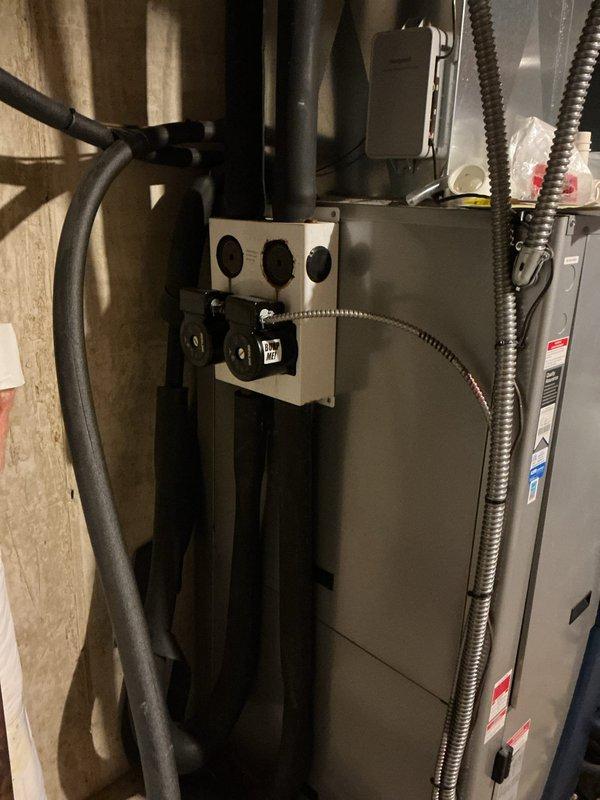 During routine heating maintenance on a 16-year-old geothermal unit located in the basement, identified a refrigerant leak on the evaporator coil evidenced by oil residue in the drain pan and oil streaking along the coil surface. Additionally discovered a failed capacitor, likely caused by compressor stress from low refrigerant charge. Due to the age of the equipment and extent of repairs needed, provided an estimate for complete system replacement.