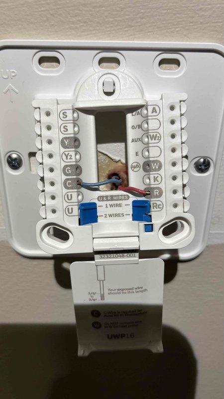 Installed Honeywell Home Elite Pro thermostat with EIM (Equipment Interface Module) model EIM007U. Completed all wiring terminations at thermostat base and interface module, verified proper connections at terminal blocks, and confirmed system power and communication status through LED indicators on the EIM board.