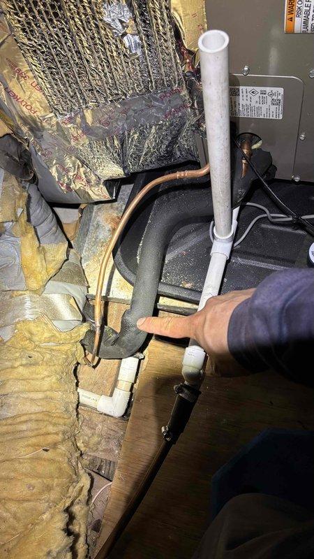 Responded to no-cool call on recently installed system. Upon arrival, found unit not powering on and confirmed previous drain line clog had been addressed. Inspected attic-mounted air handler and discovered damaged refrigerant line insulation exposing copper tubing, which was compromising system efficiency and potentially causing low voltage issues from exposed conductors near deteriorated foam. Replaced damaged insulation sections on refrigerant lines and verified all electrical connections were secure and free from moisture intrusion. System restored to proper operation with adequate airflow and cooling capacity confirmed.